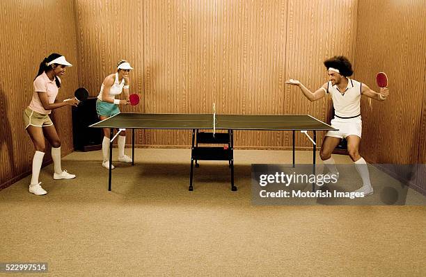 hipsters playing table tennis - women's table tennis stockfoto's en -beelden
