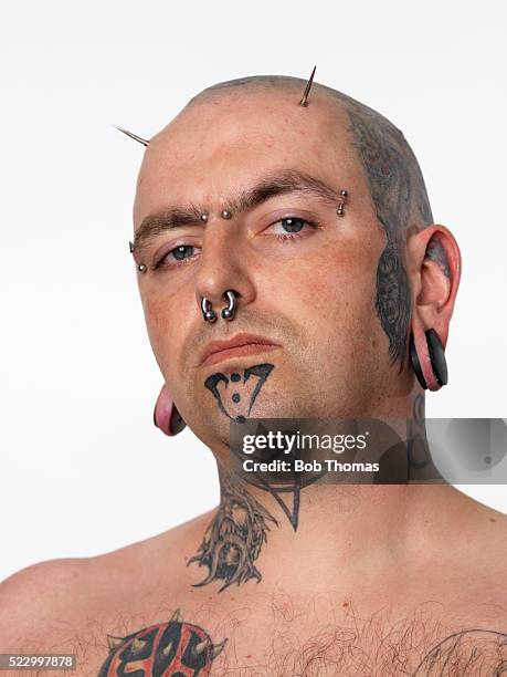 portrait of man with body art - body piercings stock-fotos und bilder