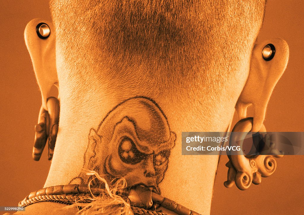 Man with Tattoo and Ear Piercings