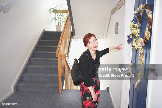 frustrated woman ringing doorbell - blocking door stock pictures, royalty-free photos & images