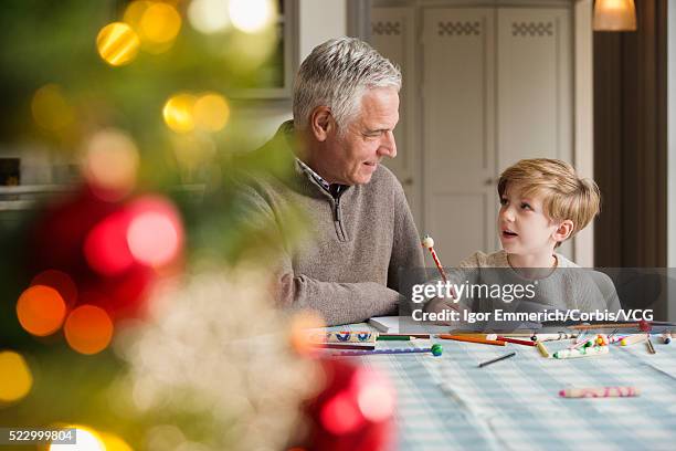 boy and grandfather coloring - christmas colouring stock pictures, royalty-free photos & images