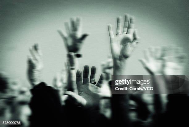 hands raised in a crowd - corbis historical stock-fotos und bilder