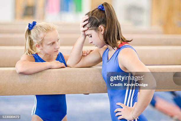 depressed gymnast being comforted by teammate - kids kindness stock pictures, royalty-free photos & images