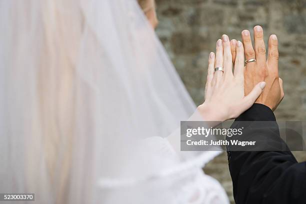 bride and groom looking at their rings - wagner wedding stock pictures, royalty-free photos & images