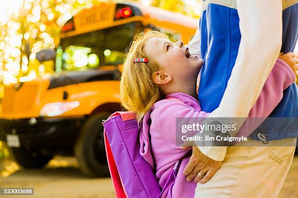 happy schoolgirl hugging her mom - back to school mom stock pictures, royalty-free photos & images