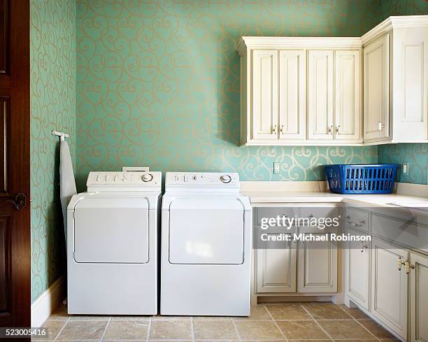 laundry room with white cabinets - buanderie photos et images de collection