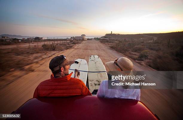 couple riding in back of pickup truck after surfing - san mateo county stockfoto's en -beelden