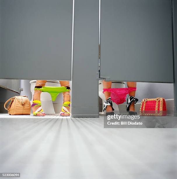 fashionable young women using public restroom - public restroom stock pictures, royalty-free photos & images