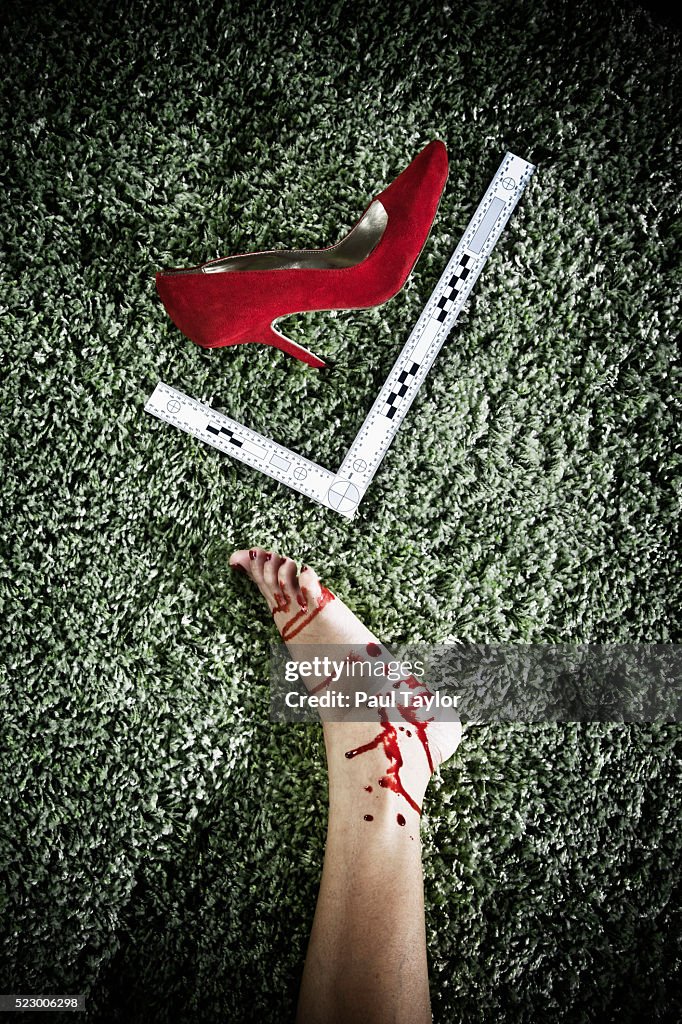 Foot and shoe of dead woman at a crime scene