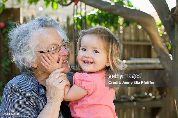 grandma hugging toddler granddaughter (2-3), california, usa - jenny69 stock pictures, royalty-free photos & images