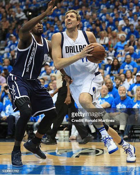 Dirk Nowitzki of the Dallas Mavericks dribbles the ball against Serge Ibaka of the Oklahoma City Thunder during game three of the Western Conference...