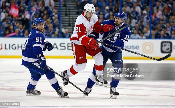 Tomas Tatar of the Detroit Red Wings splits the defense of Valtteri Filppula and Alex Killorn of the Tampa Bay Lightning during the first period in...