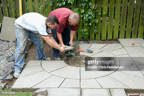 men laying patio - brick patio stock pictures, royalty-free photos & images