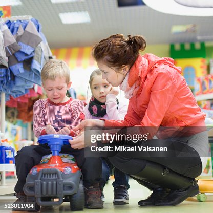Mother comforting son in department store Mother comforting son in department store