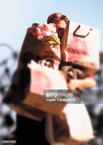 man struggling with grocery bags - struggle stock pictures, royalty-free photos & images