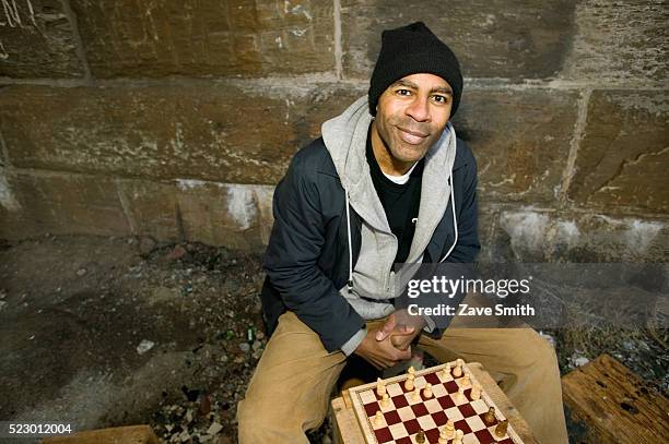 man with chess board - homeless person stockfoto's en -beelden