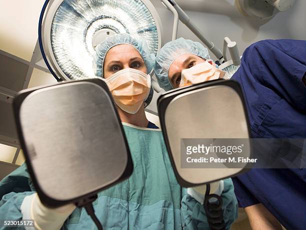 surgeons using defibrillator - defibrillation stock pictures, royalty-free photos & images