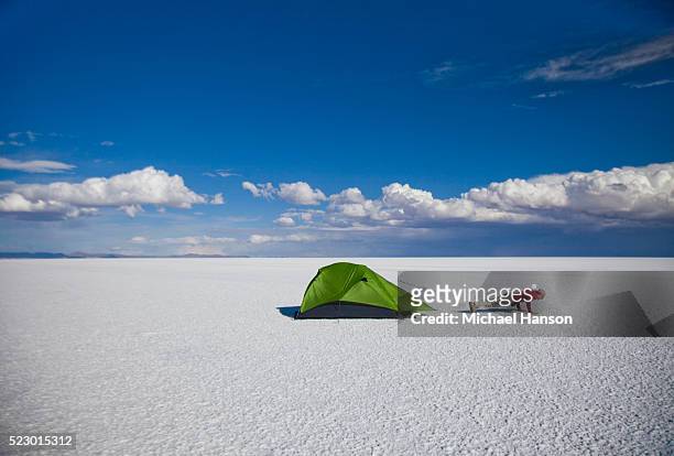 man doing pushups next to his tent in middle of salt flat - bolivia daily life stock pictures, royalty-free photos & images