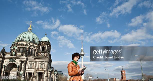 woman looking at city map - berlin map stock pictures, royalty-free photos & images