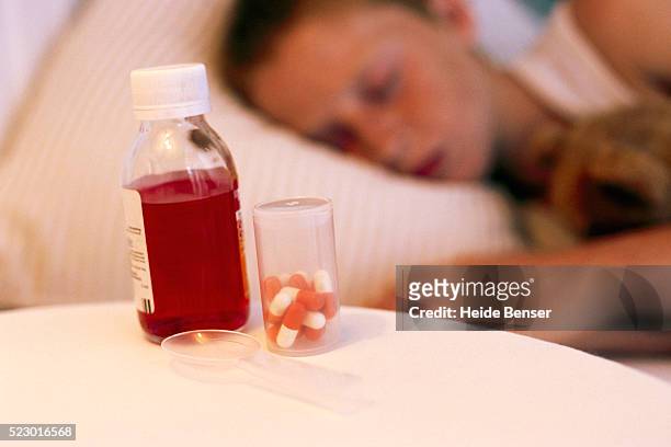 medicine bottles on boy's bedside table - bedside table kid asleep stock pictures, royalty-free photos & images