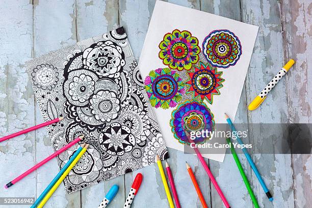 coloring mandalas on paper - color pencils fotografías e imágenes de stock