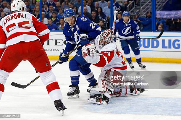 Petr Mrazek of the Detroit Red Wings makes a save behind Ryan Callahan of the Tampa Bay Lightning as Niklas Kronwall looks on during the second...