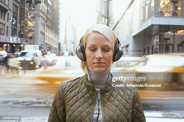 woman wearing headphones - serene people stockfoto's en -beelden
