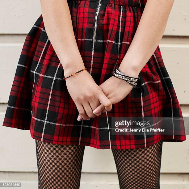 midsection of teen (16-17) girl wearing plaid skirt - girls in plaid skirts foto e immagini stock