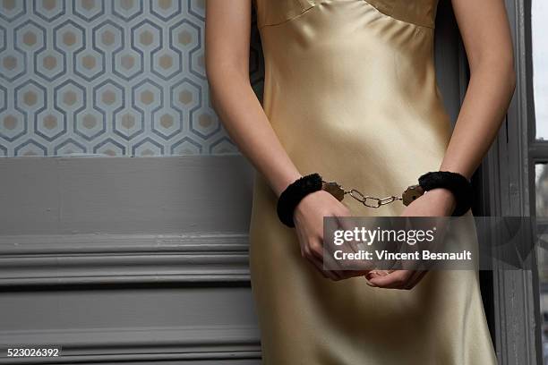 woman wearing handcuffs - fetisj stock pictures, royalty-free photos & images