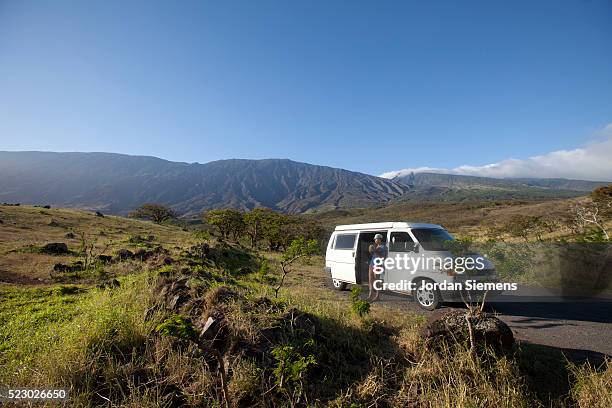 a woman enjoying the view of a volcano in hawaii. - kahului maui stock pictures, royalty-free photos & images