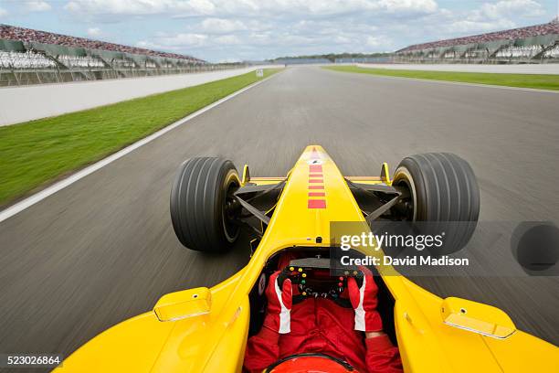 racecar driver steering down the straight - race car driver stock pictures, royalty-free photos & images