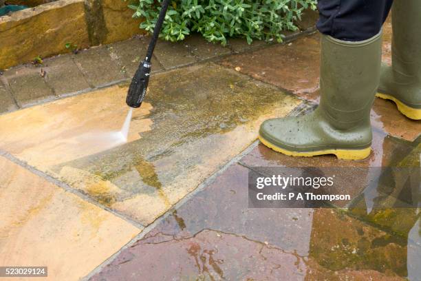 man jet washing patio - sandstone stock pictures, royalty-free photos & images