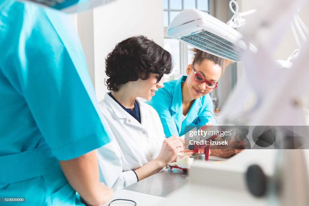 Multi ethnic female students learning prosthetic dentistry