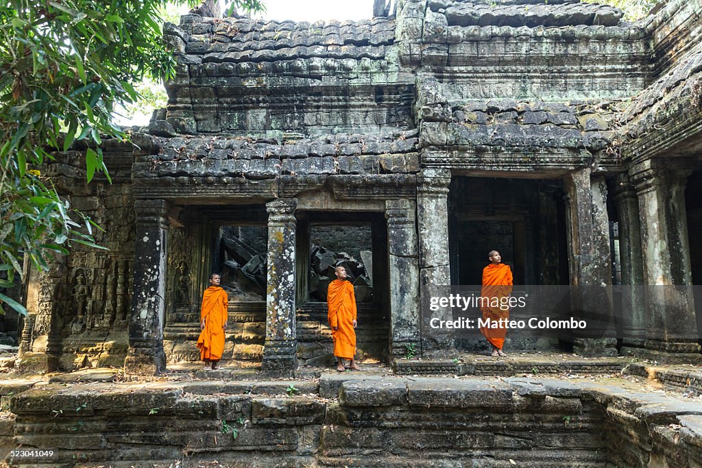 Three buddhist monks at Angkor wat