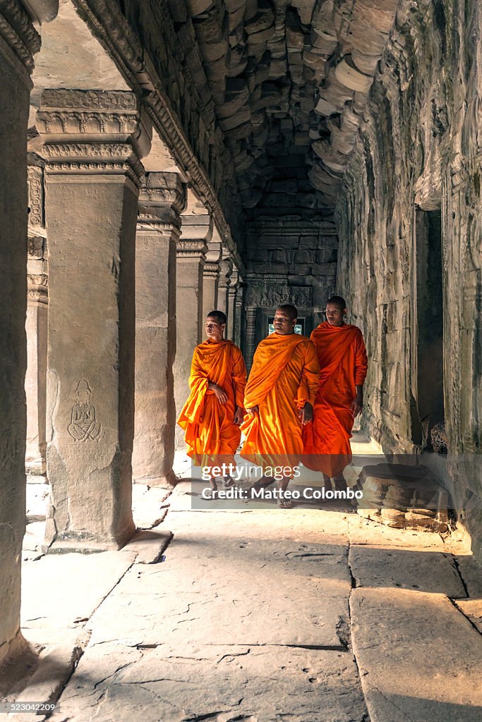 Three buddhist monks inside temple, Angkor Wat