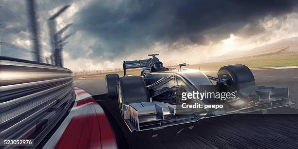 racing car during race on track at sunset - car racing stock pictures, royalty-free photos & images