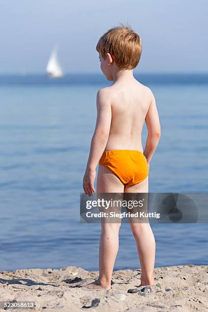 young boy on the beach, kuehlungsborn, mecklenburg-western pomerania, germany, europe - speedo boy stock pictures, royalty-free photos & images