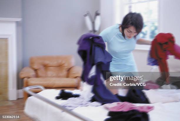 woman frantically dressing - searching mess stock-fotos und bilder