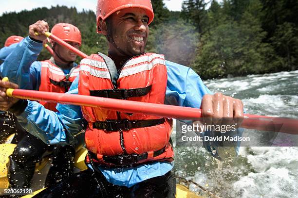group of men whitewater rafting - rafting stock pictures, royalty-free photos & images