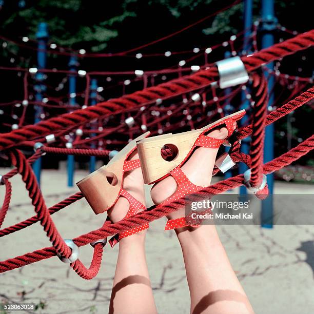 woman's feet stuck on playground equipment - careless stock pictures, royalty-free photos & images