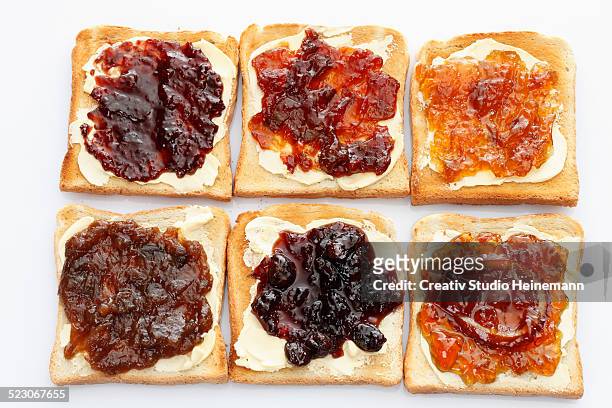 six slices of toast with various jams, rhubarb jam, apricot jam, strawberry jam, orange marmalade, cherry jam and ginger marmalade - rhubarb bread stock pictures, royalty-free photos & images