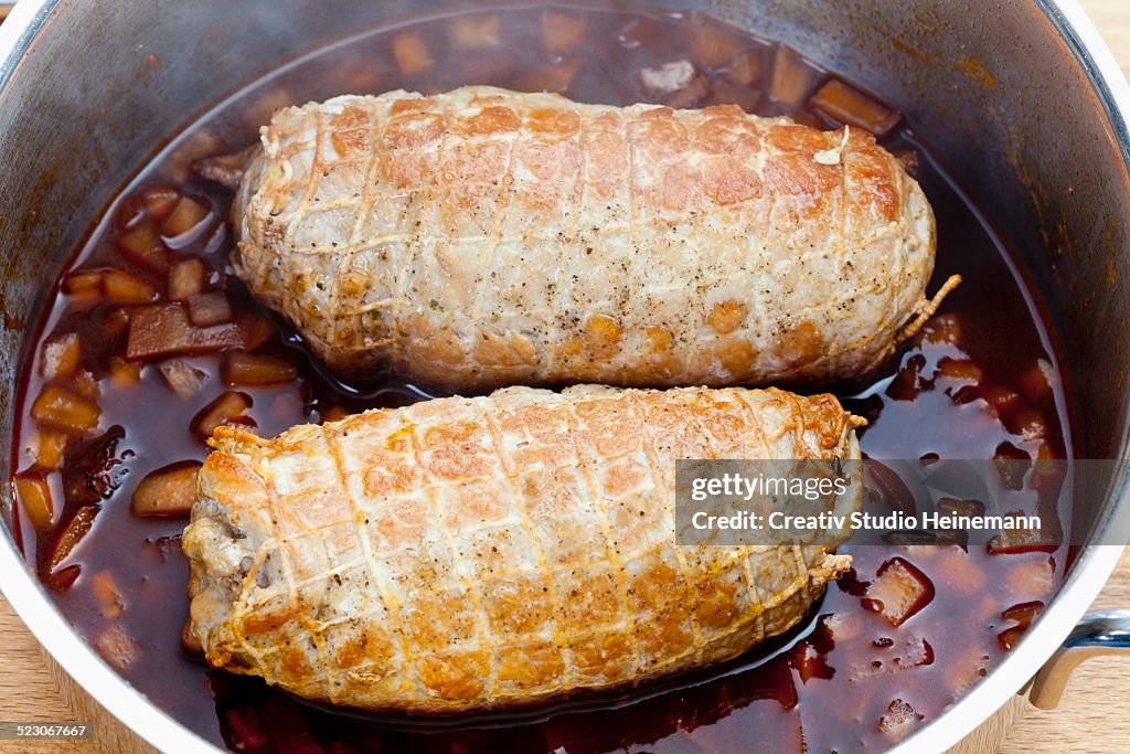 Pork roulade in a net in a casserole pot