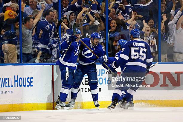 Alex Killorn of the Tampa Bay Lightning celebrates his goal against the Detroit Red Wings with teammates Matt Carle and Braydon Coburn during the...