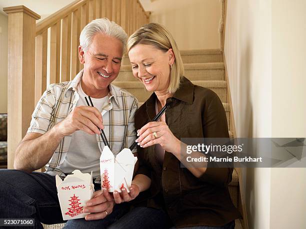 couple enjoying chinese food on stairs - chinese takeout stock pictures, royalty-free photos & images