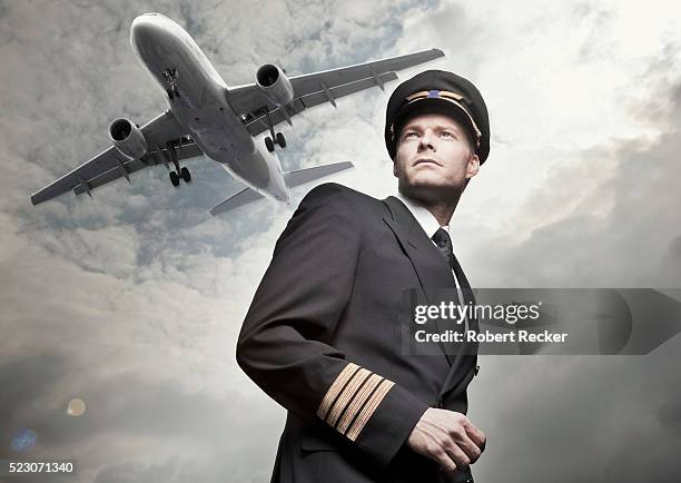 airplane flying over pilot - captain hat stock-fotos und bilder