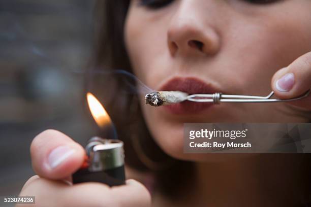 woman smoking joint - smoking weed stock-fotos und bilder