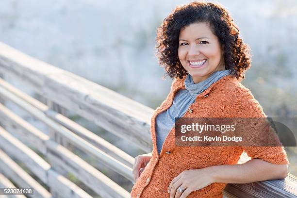 woman leaning against fence - 45 outdoors stock pictures, royalty-free photos & images