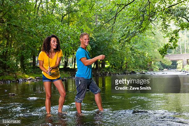 young couple fishing in river, coatesville, pennsylvania, usa - coatesville stock pictures, royalty-free photos & images