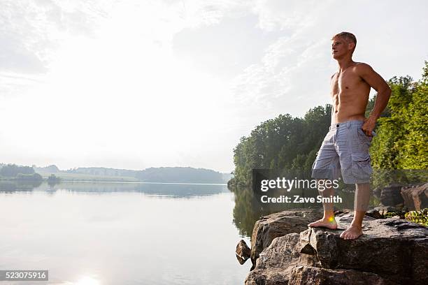 young man standing on river bank, coatesville, pennsylvania, usa - coatesville stock pictures, royalty-free photos & images