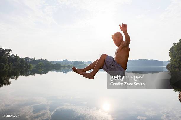 young man jumping into river, coatesville, pennsylvania, usa - coatesville stock pictures, royalty-free photos & images